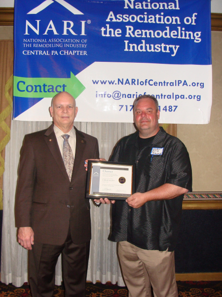NARI past president Michael Hydeck, MCR, CKBR presents NARI Central PA chapter president Joseph Sullenberger with a new chapter charter at the first Meet & Mingle meeting on April 18, 2013.
