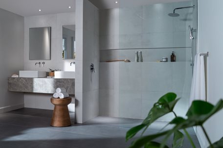 A bathroom with a large showerDescription automatically generated