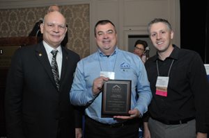 Past president Michael Hydeck, MCR, CKBR, presents the NARI of Greater Charlotte Chapter with the Chapter Excellence Award at the 2013 Spring Business Meeting held in Kansas City, Mo.